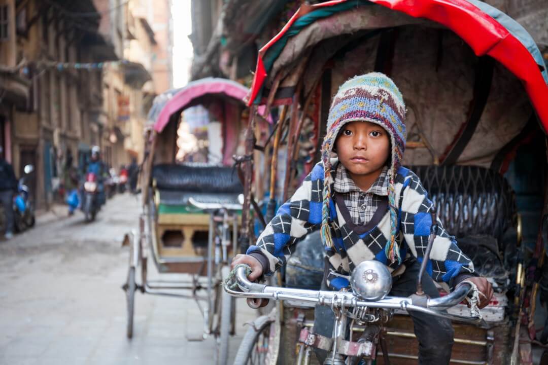 small boy in rickshaw